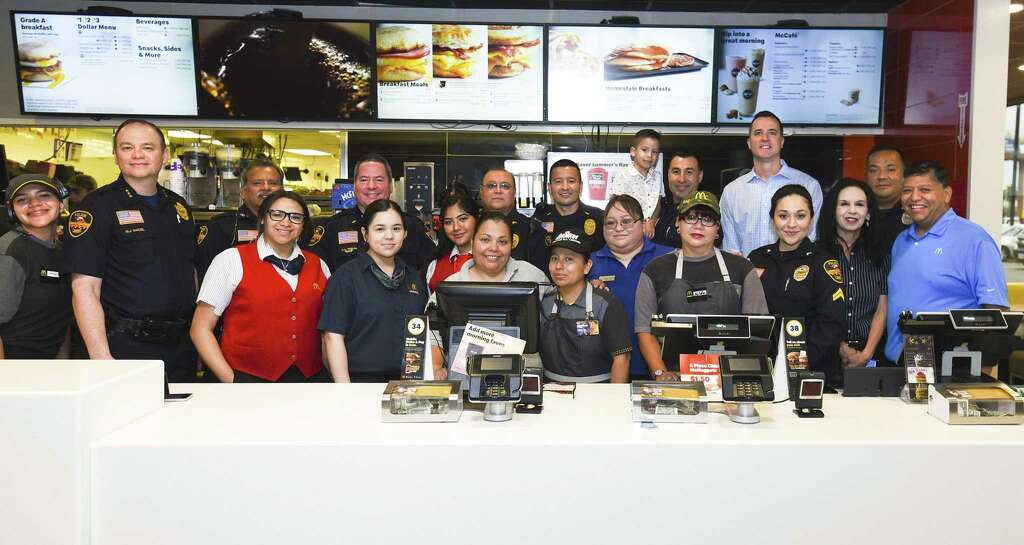 <p>McDonald's of Laredo on Saunders staff and owner pose for a photo with Laredo Police Saturday during the LPD Coffee with a Cop event.</p>