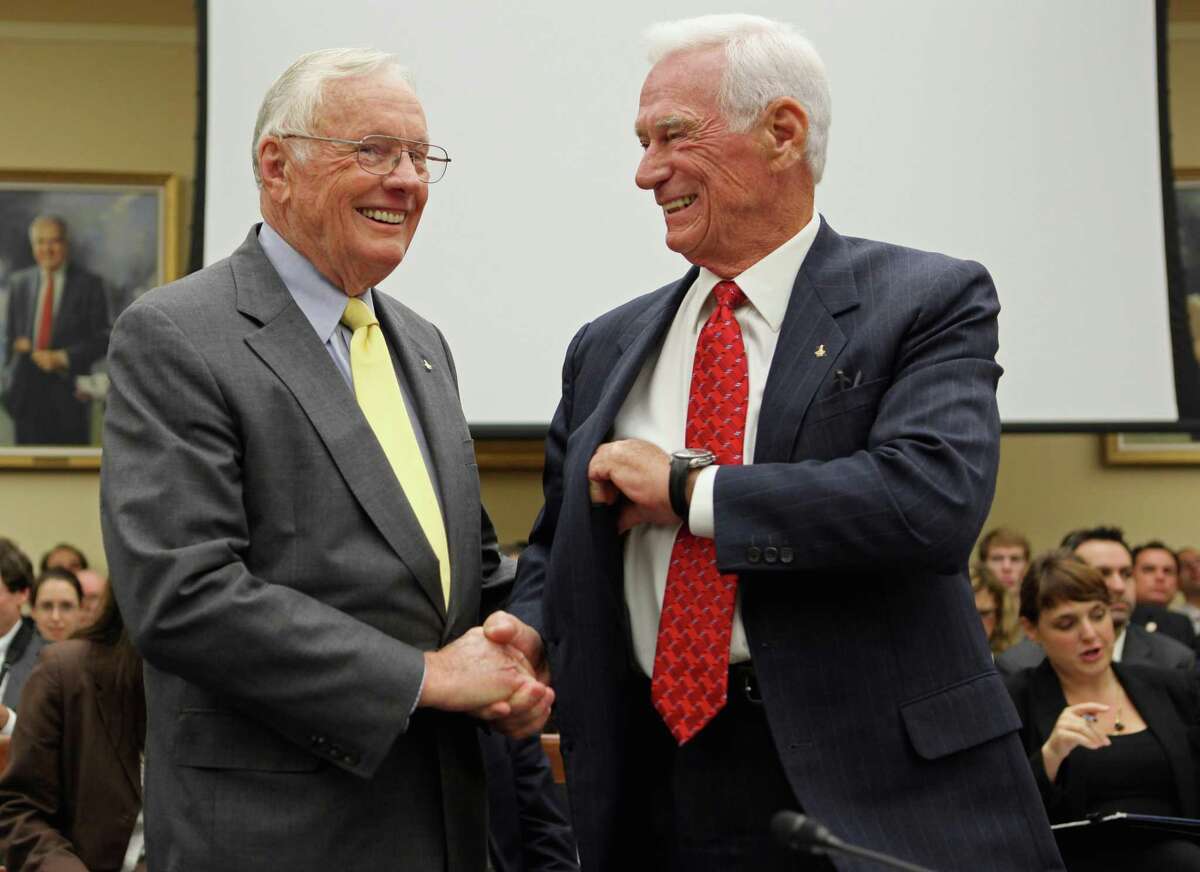 Astronaut and commander of the Apollo 11 mission Neil Armstrong (L) shakes hands with astronaut and commander of the Apollo 17 mission Gene Cernan before they testify to the House Science, Space, and Technology Committee about human space flight on Capitol Hill on Sept. 22, 2011, in Washington, D.C. Armstrong was the first human to walk on the moon and Cernan was the last.