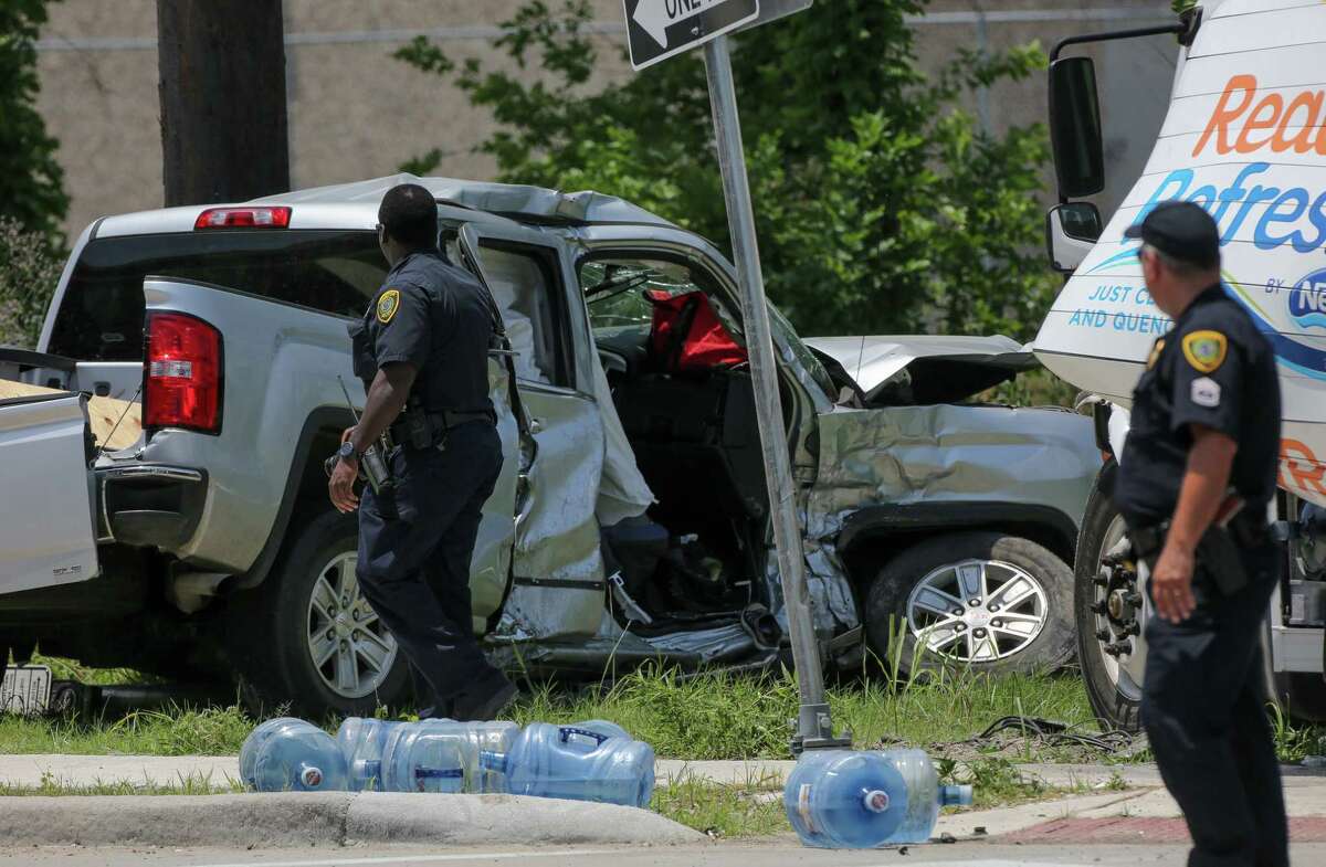Houston Police officers investigate the scene of a three-vehicle fatal crash at the intersection of Gessner Road and Northwest Freeway Monday, May 20, 2019, in Houston.