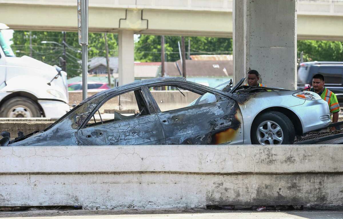 Houston Police officers and Houston Fire Department firefighters responded to the scene of a fatal car fire on the off ramp of the Eastex Freeway, near Tidwell Road Monday, May 20, 2019, in Houston.