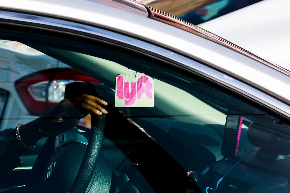 A Lyft decal is seen through the window of a car outside the Cal Train station on Townsend Street in San Francisco, California, on Monday, May 20, 2019.