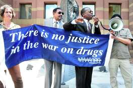 Activists speak at a protest about the War on Drugs in front of CIty Hall in New Haven, Connecticut in 2013. We’ve been losing this war for awhile — but maybe that’s the point.