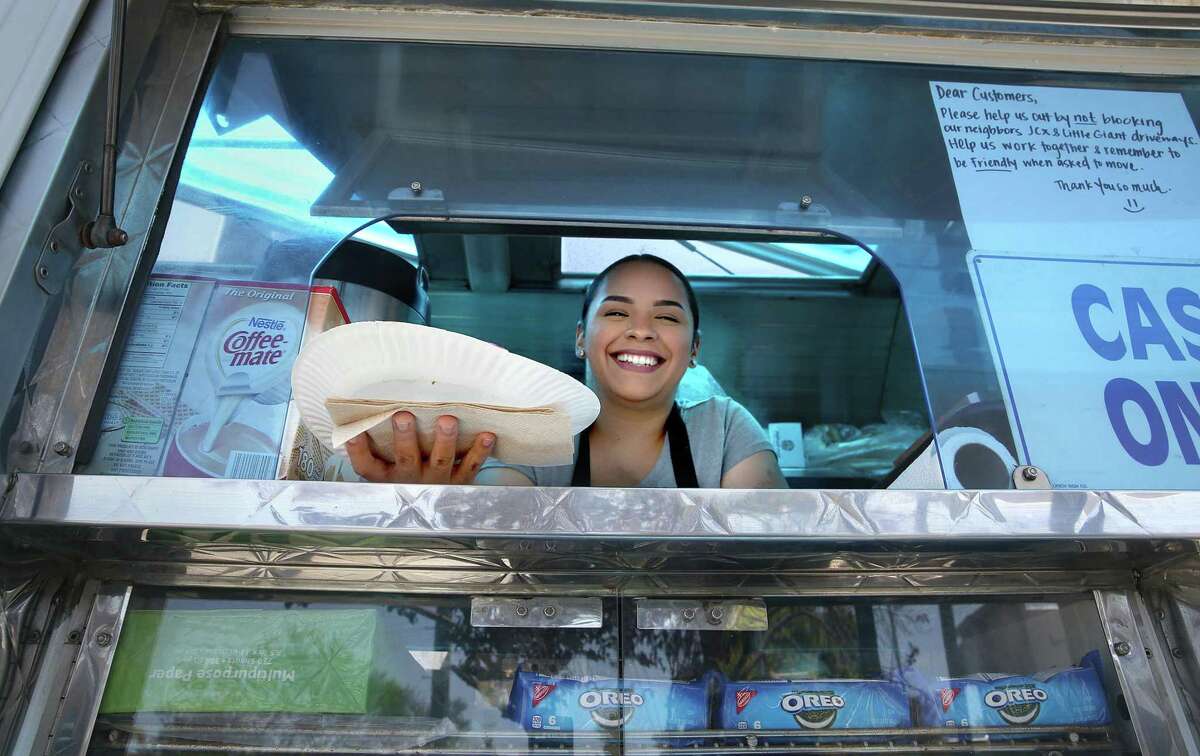 Stephanie Perez serves a taco at El Gallo Giro taco truck in S.F.