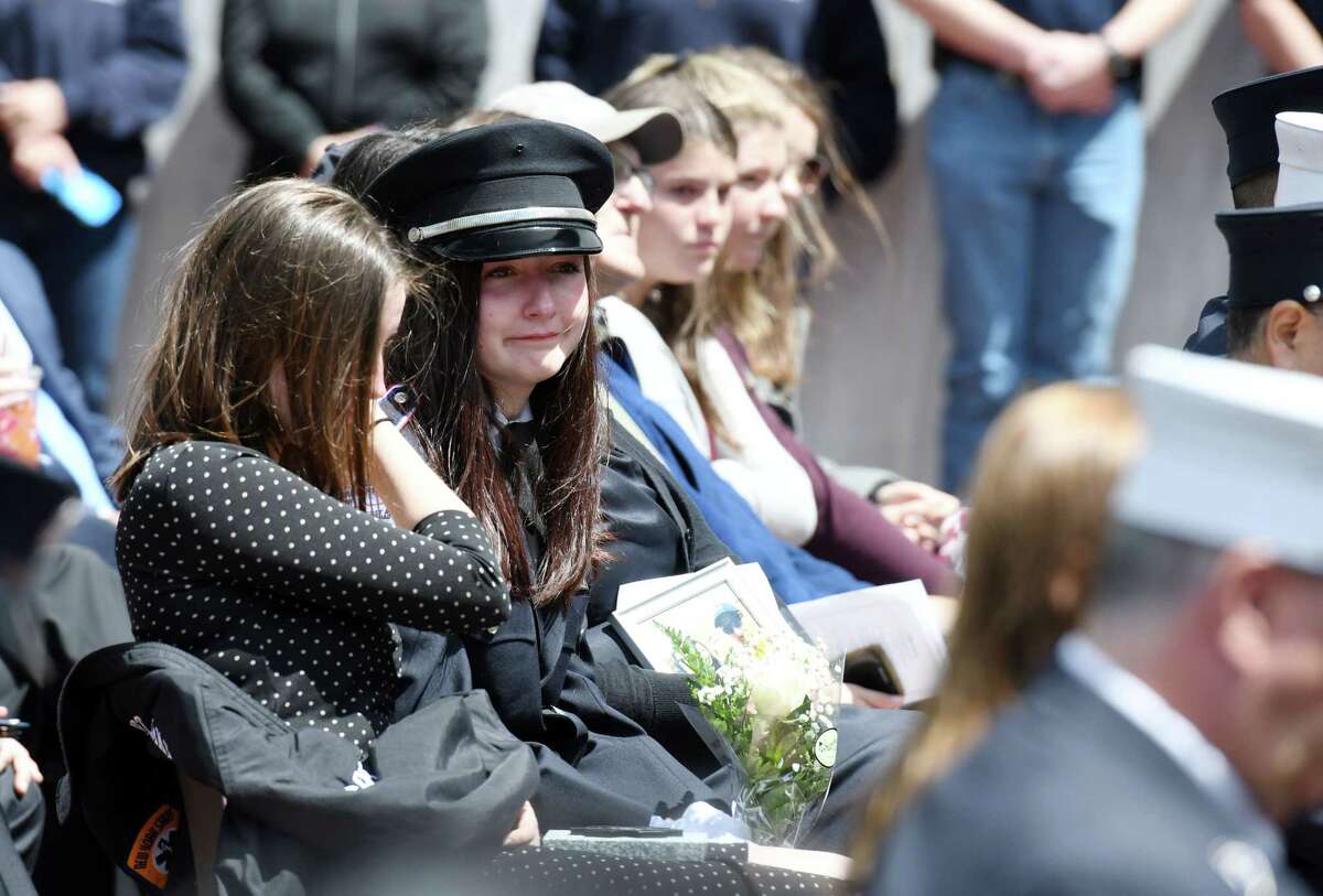 From left, Caroline Ryan, 17, and Michaela Ryan, 19, tear up after receiving a star of life in honor of their late father, William Ryan who served the Bay Community VAC, during a ceremony commemorating the lives of seven first responders on Tuesday, May 21, 2019 at the Empire State Plaza in Albany, NY. (Phoebe Sheehan/Times Union)