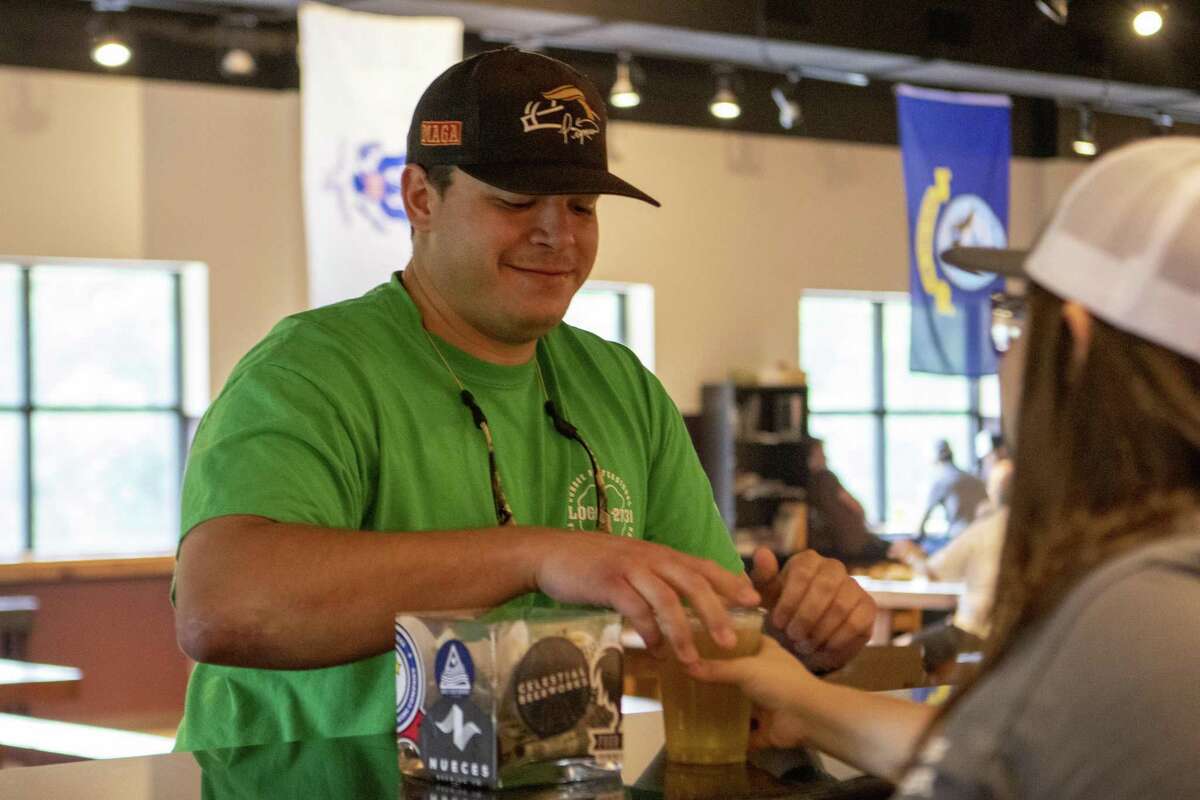 Stephen Kolb with the Conroe Fire Department picks up a glass of Local 2731 at the bar during a beer tasting Saturday, May 18, 2019 at Southern Star Brewing Company in Conroe.