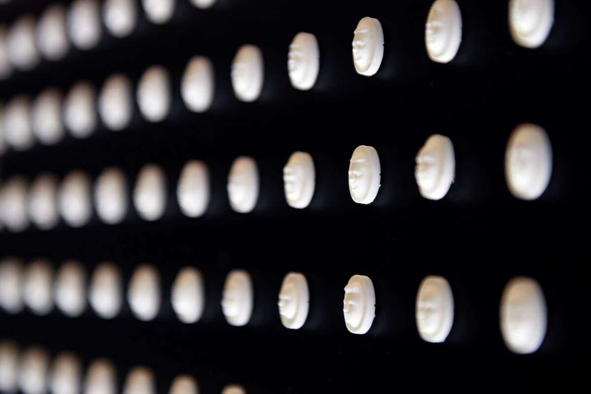 22,000 pills with faces engraved into them represent those who died from prescribed opioids in 2015 at the Prescribed to Death: A Memorial to the Victims of the Opioid Crisis exhibit on Tuesday, May 21, 2019 at Empire State Plaza in Albany, NY. (Phoebe Sheehan/Times Union)