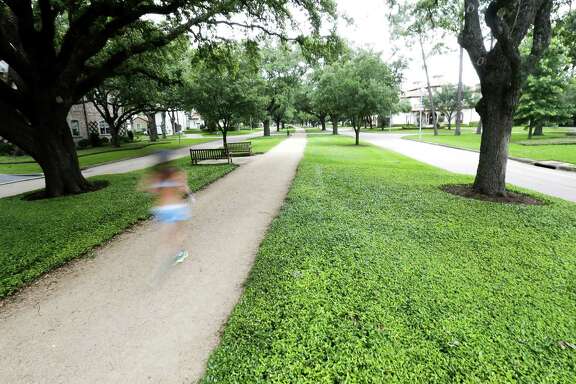 A runner on a path on Tanglewood Blvd,. in the Tanglewood neighborhood on Tuesday, May 21, 2019 in Houston. The Tanglewood residents are suing to keep a high-rise development out of their neighborhood.