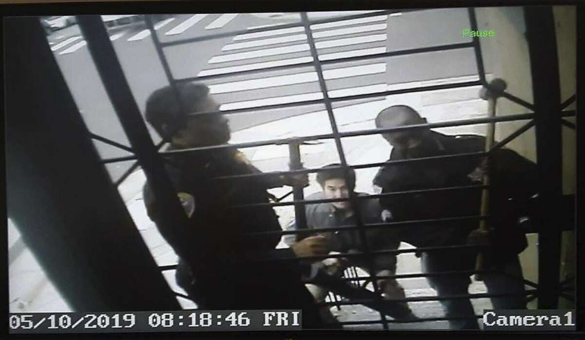 In this May 10, 2019, image from video provided by Bryan Carmody San Francisco police armed with sledgehammers execute a search warrant at journalist Bryan Carmody's home in San Francisco. The San Francisco reporter is seeking the return of property after police raided his home, as officials sought to determine the source of a leaked police report into the death of the city's public defender. An attorney for Carmody will make the request Tuesday, May 21 in San Francisco County Superior Court. (Bryan Carmody/@bryanccarmody via AP)