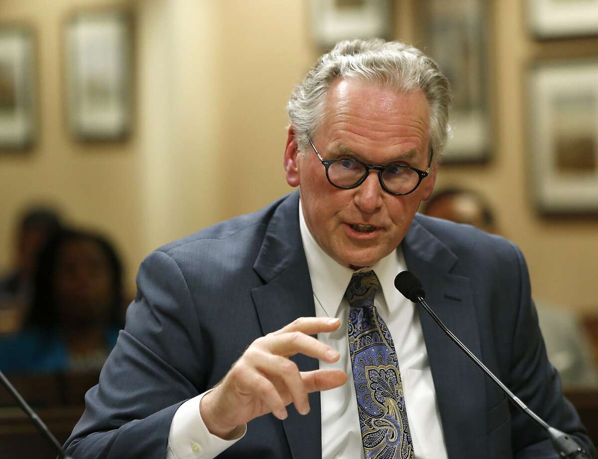 William Johnson the newly appointed chief executive officer of Pacific Gas & Electric Corp.,responds to a lawmaker's question while appearing before the Assembly Utilities and Energy Committee Wednesday, May 15, 2019, in Sacramento, Calif. Johnson was speaking to lawmakers when California fire authorities announced PG&E's power lines sparked last year's deadly wildfire that nearly destroyed the town of Paradise. (AP Photo/Rich Pedroncelli)