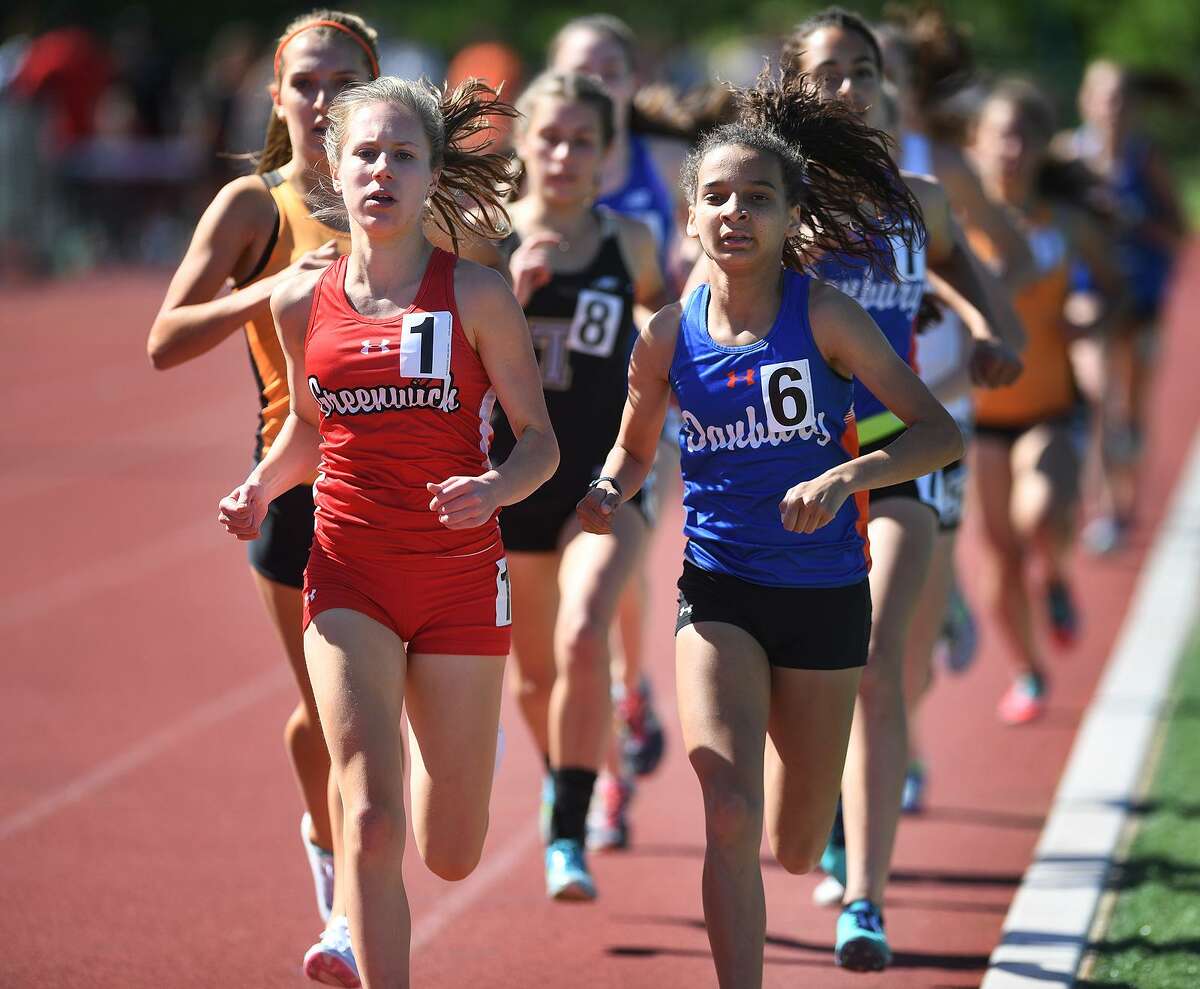 Greenwich’s Mari Noble, left, makes her move on her way to winning the 1,600 meters at the FCIAC Outdoor Track and Field Championship on Tuesday at Southern Connecticut State University in New Haven.