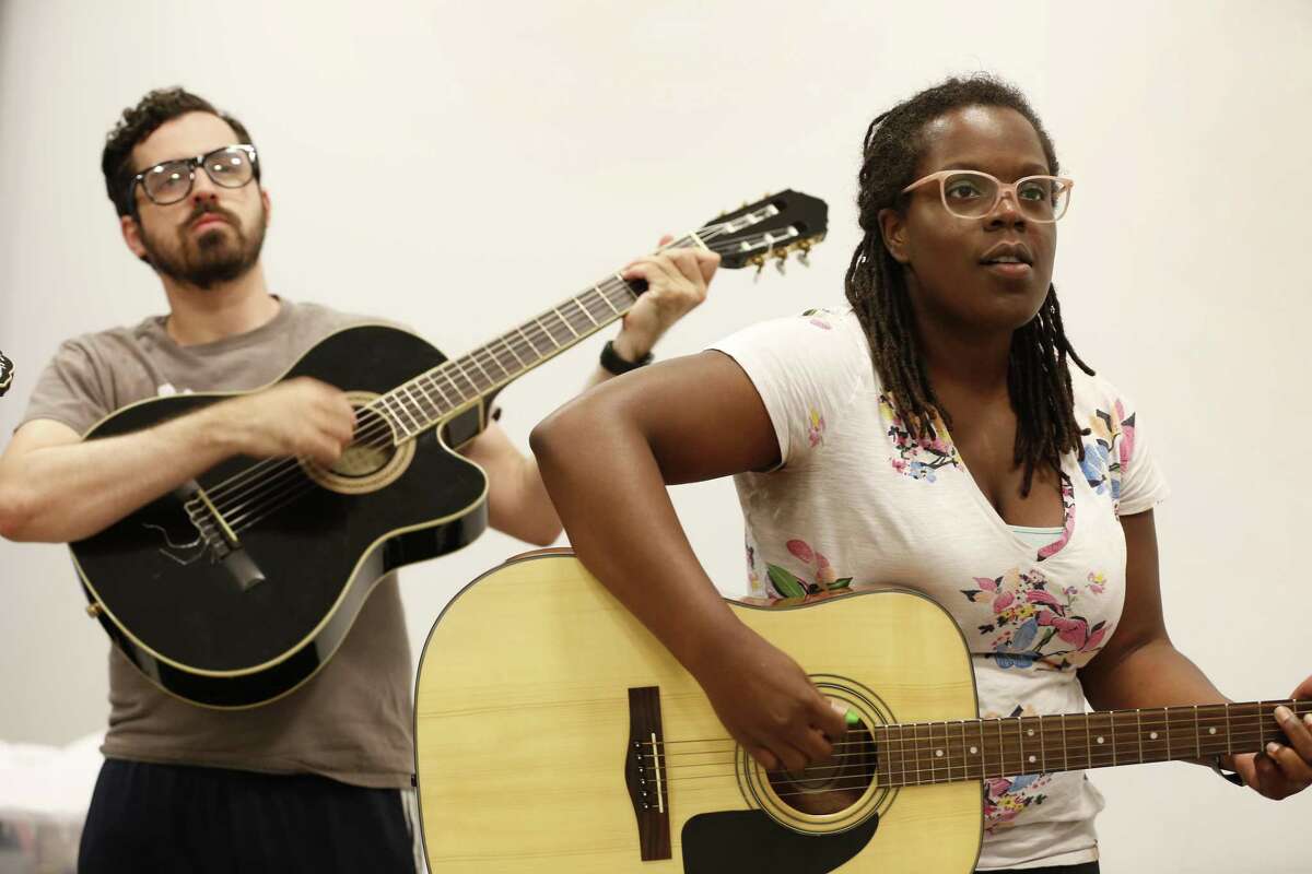 Bryan Kaplin (l-r) and Mara McGhee play their guitar with members of the upcoming rock opera 'Speeding Motorcycle' during rehearsal at the Catastrophic Theater at MATCH Monday, May 20, 2019, in Houston.