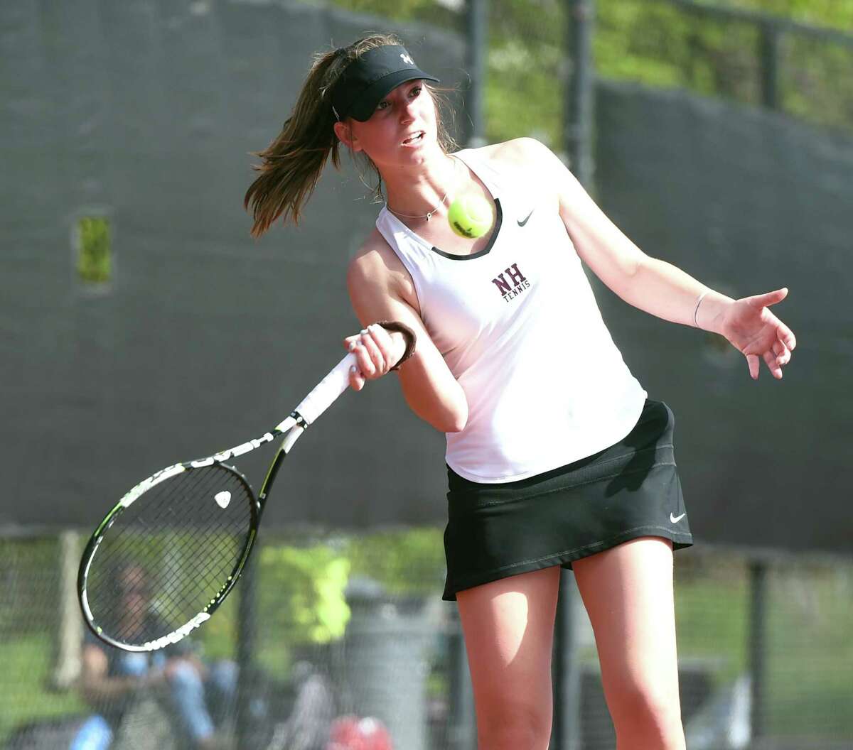 North Haven’s Julia Migliorini hits a forehand against Hand’s Sam Riordan on May 6.