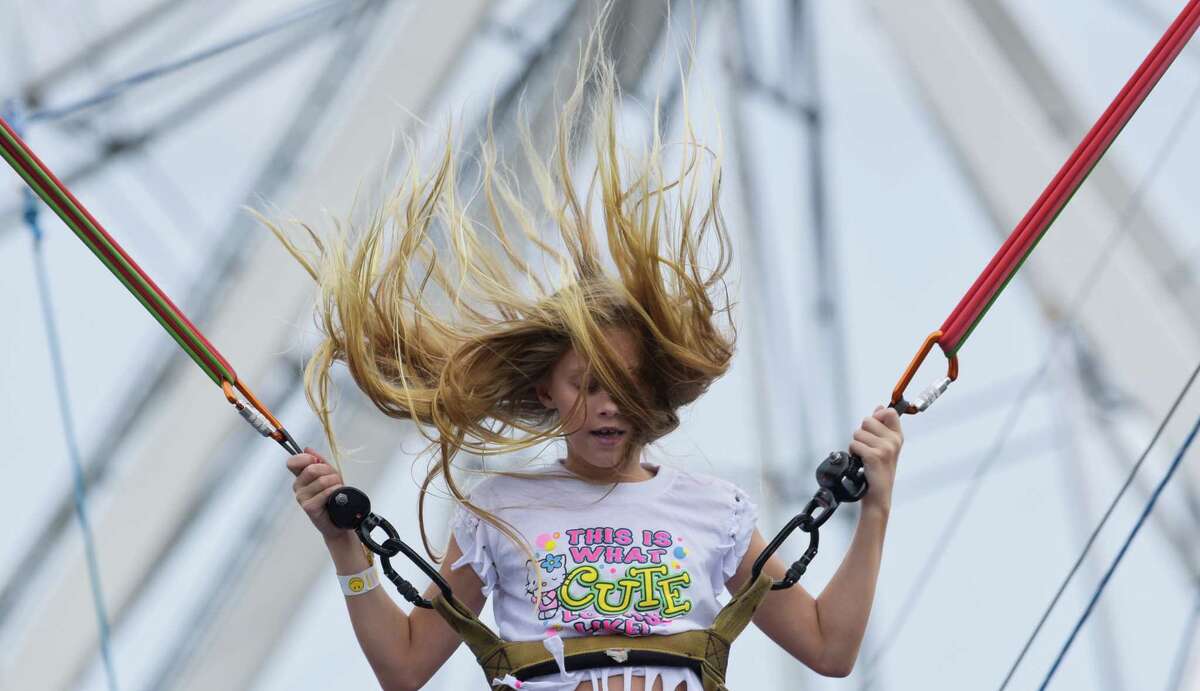 Cianna Partak's hair flies around as she plays on the Bungee Bounce ride on the final day of the Altamont Fair on Sunday, Aug. 19, 2018, in Altamont, N.Y. (Paul Buckowski/Times Union)
