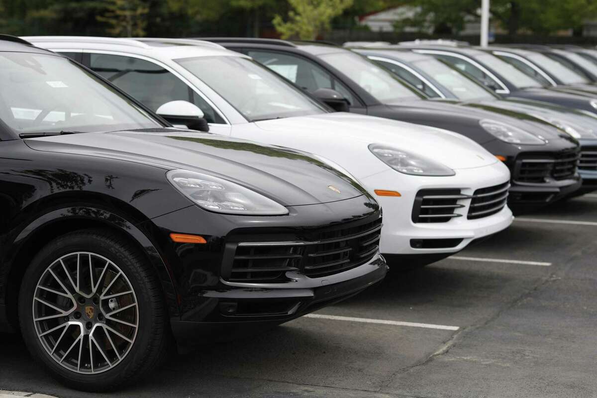 A line of new 2019 Cayenne sports-utility vehicles sits at a Porsche dealership in Littleton, Colo.