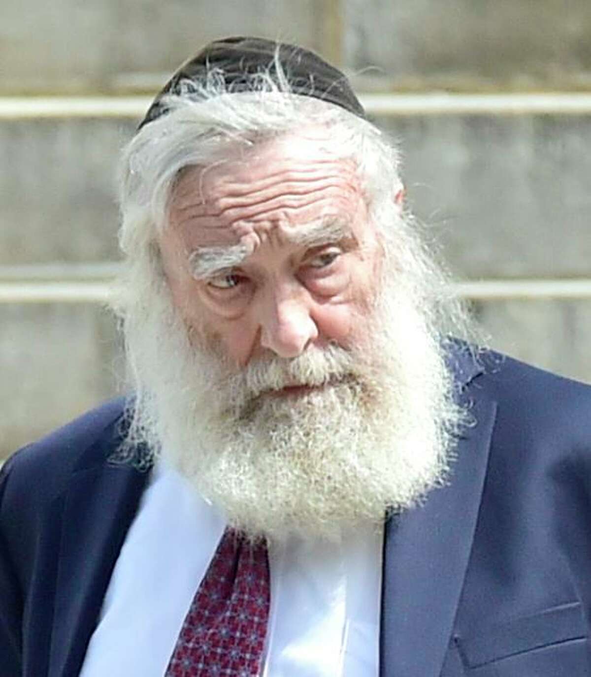 Rabbi Daniel Greer, 77, of New Haven, leaves New Haven Superior Court on Elm Street in New Haven, Conn. Monday, August 14, 2017 after he was arraigned on a criminal charge of second-degree sexual assault and risk of injury to a minor. Greer did not enter a plea. The alleged victim in the criminal charge is Eliyahu Mirlis, of New Jersey, who was awarded $15 million in in his civil lawsuit against Greer in May of 2016. Greer was a dean of the Yeshiva of New Haven/the Gan School, where the alleged victim was a high school student. Greer was accused in May 2016 of repeatedly sexually assaulting Mirlis, of New Jersey, over several years in the early- to mid-2000s. Mirlis attended the school from 2001 to 2005. Greer has denied the allegations.