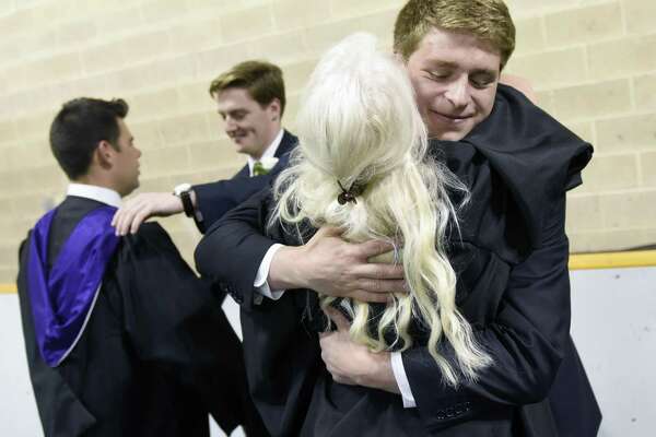 Keegan Drew, of Harrison, N.Y., hugs teacher Dawn Dawn Berrocal before the Brunswick School 117th Commencement. t Brunswick's School's Dann Gymnasium in Greenwich, Conn. Wednesday, May 22, 2019. Retired Supreme Court Associate Justice Anthony M. Kennedy gave the commencement speech before 100 new graduates walked across the stage.