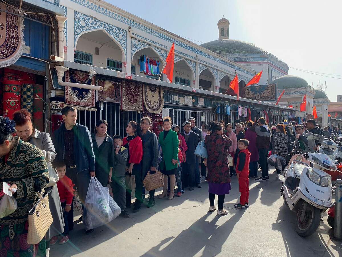 FILE -- Shoppers line up for identification checks outside the Kashgar Bazaar in the Xinjiang region of China, Oct. 21, 2018. China’s leaders are investing billions of dollars in high-tech surveillance, making Xinjiang an incubator for increasingly intrusive policing systems that could spread across the country and beyond. (Paul Mozur/The New York Times)
