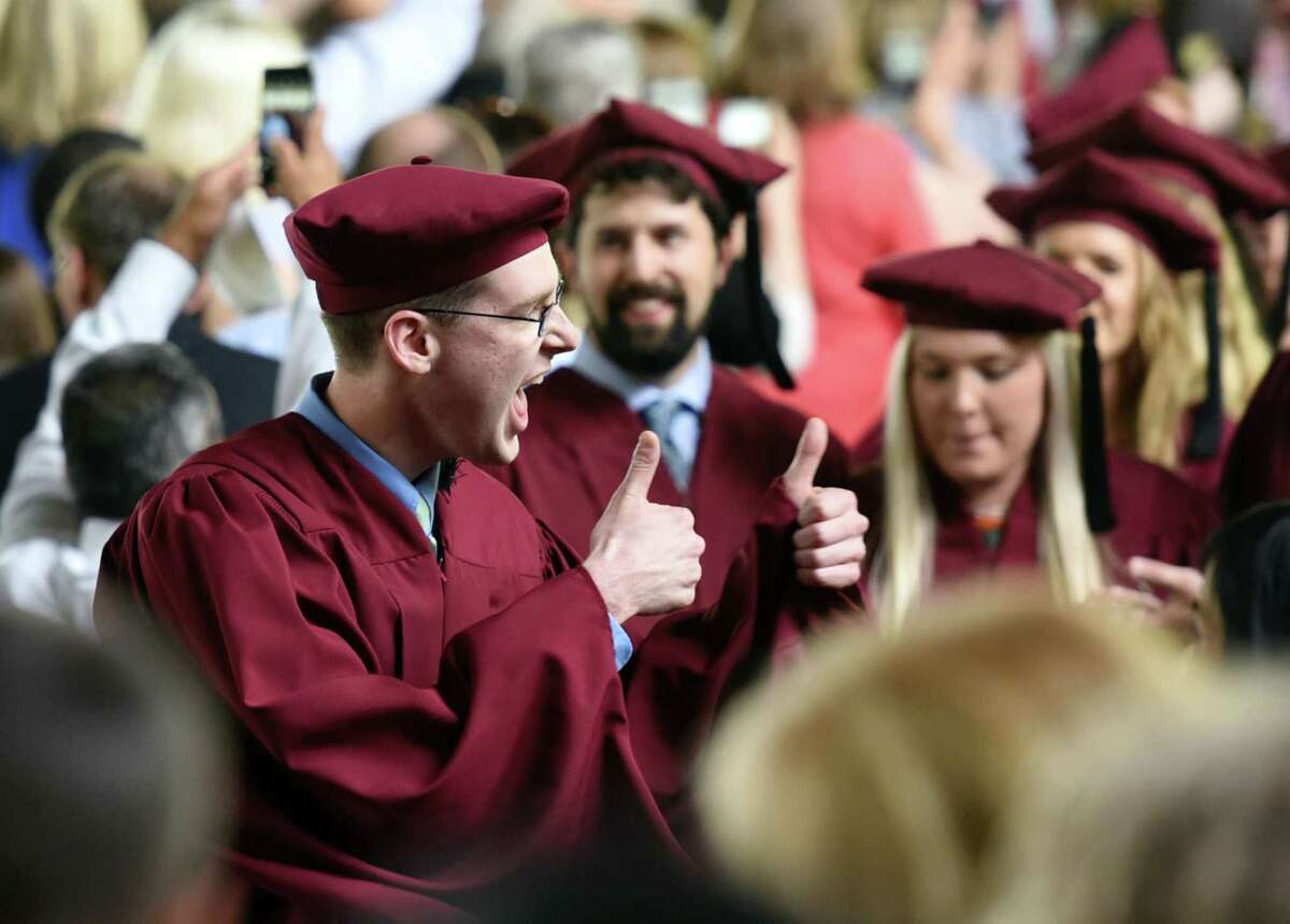 A graduate gives a 'thumbs up' signal to the crowd while proceeding down the aisle during the Albany Medical College commencement ceremony on Thursday, May 23, 2019 at the Saratoga Performing Arts Center in Saratoga Springs, NY. (Phoebe Sheehan/Times Union)