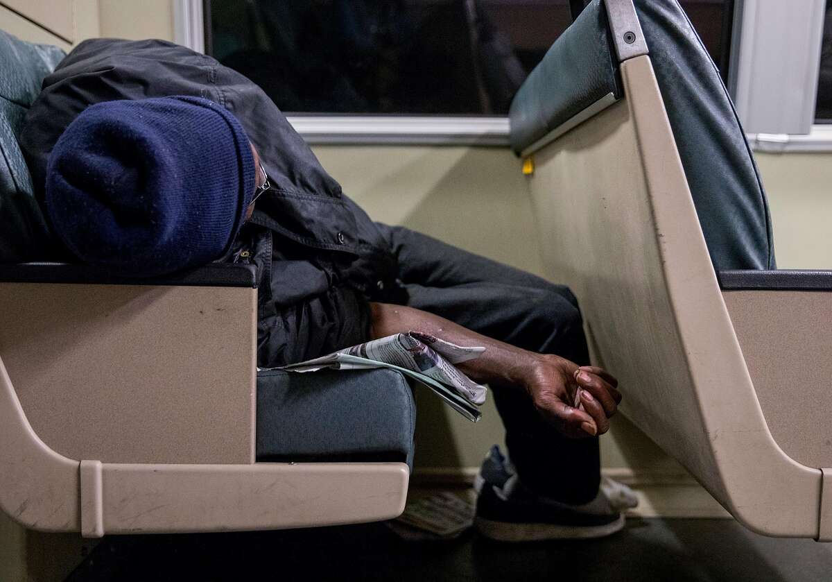 A homeless man sleeps on the back of a BART train en route to the West Oakland BART Station in Oakland, Calif. Thursday, May 23, 2019.