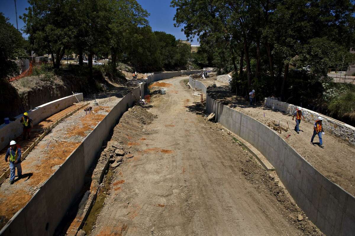 Workers are seen from the Ninth Street bridge walking down the banks of the San Antonio River’s Museum Reach project on June 19, 2008, while it was under construction. The river extension would open 11 months later.