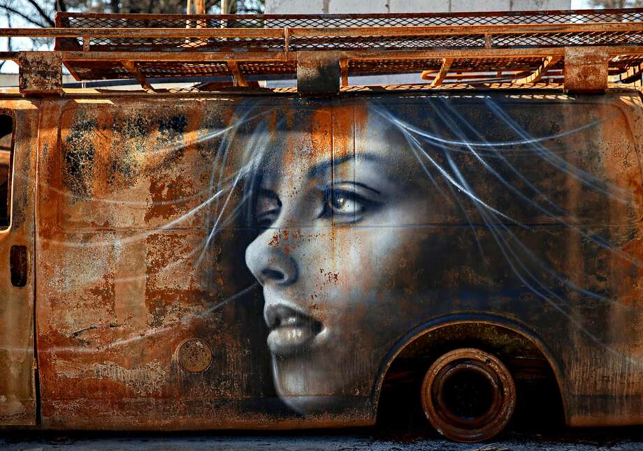 A mural painted by artist Shane Grammer is seen on what's left of a van charred by last year's Camp Fire in Paradise, Calif. Saturday, May 4, 2019. Photo: Jessica Christian / The Chronicle