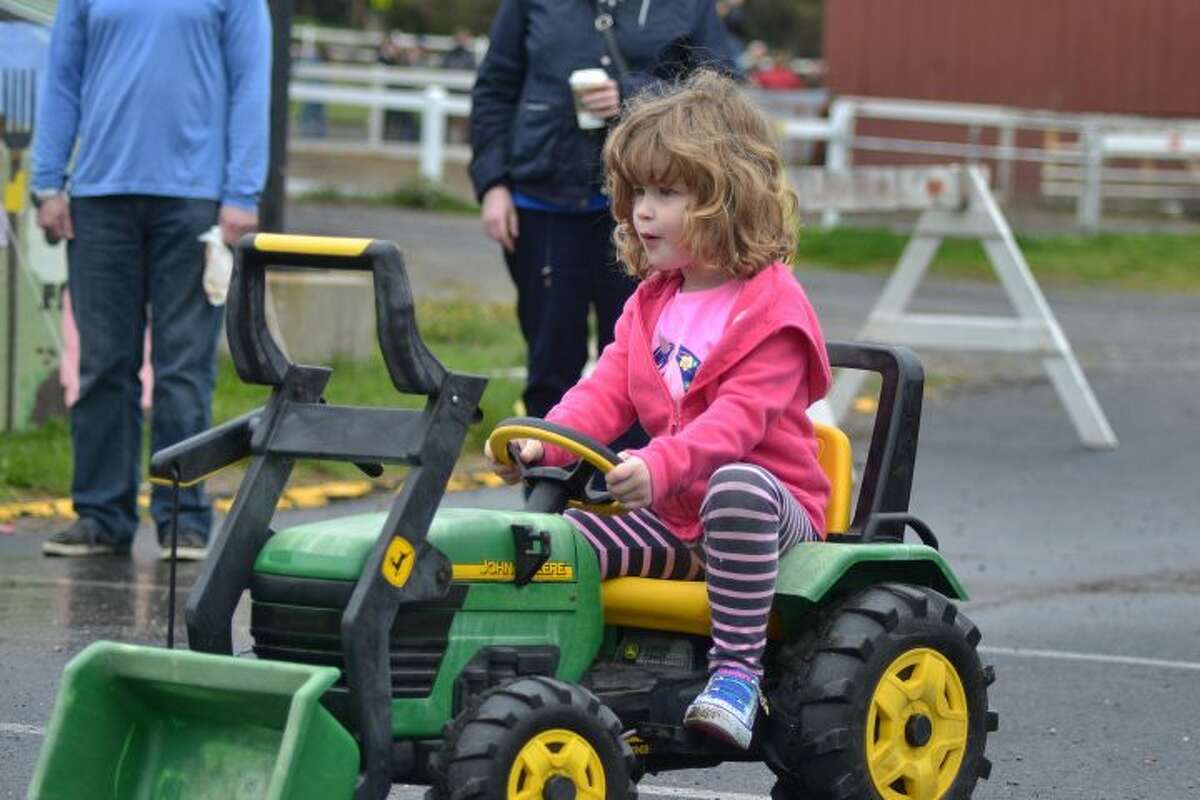 Five-year-old Clair Lidington rides a Tractor at the Agriscience Biotechnology Center's Farm Fair and Mother's Day Plant Sale - Lisa Romanchick photo