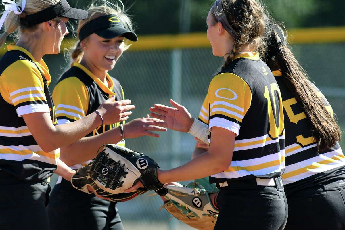 Klein Oak 2nd baseman Allie Saville, center, is all smiles with teammates Paige Hulsey, left, Bailey Eggleston (10) and Eryn Sanchez (55) as they get ready to go to work in the bottom of the third inning against Klein with a 10-2 lead over the Lady Bearkats in their District 15-6A play-in game at Klein Cain High School on April 19, 2019.
