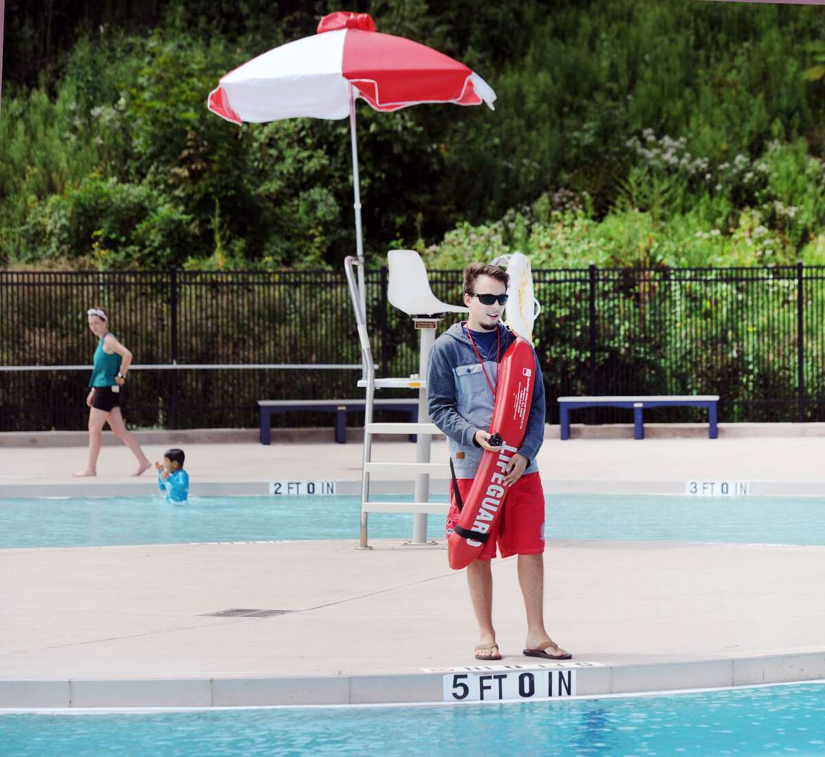 A lifeguard on duty at the Byram Park Pool in Greenwich, Conn., Friday, Aug. 31, 2018. Lifeguards are exempt from a town ban on flip-flops for employees.