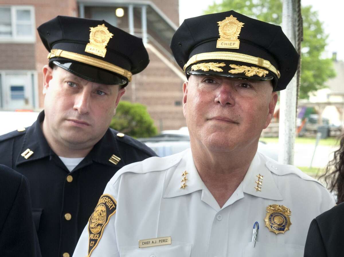 Police Captain Mark Straubel, left, stands behind Chief Armondo “A.J.” Perez during a press conference at the Charles F. Greene Homes in Bridgeport, Conn. June 16, 2017.