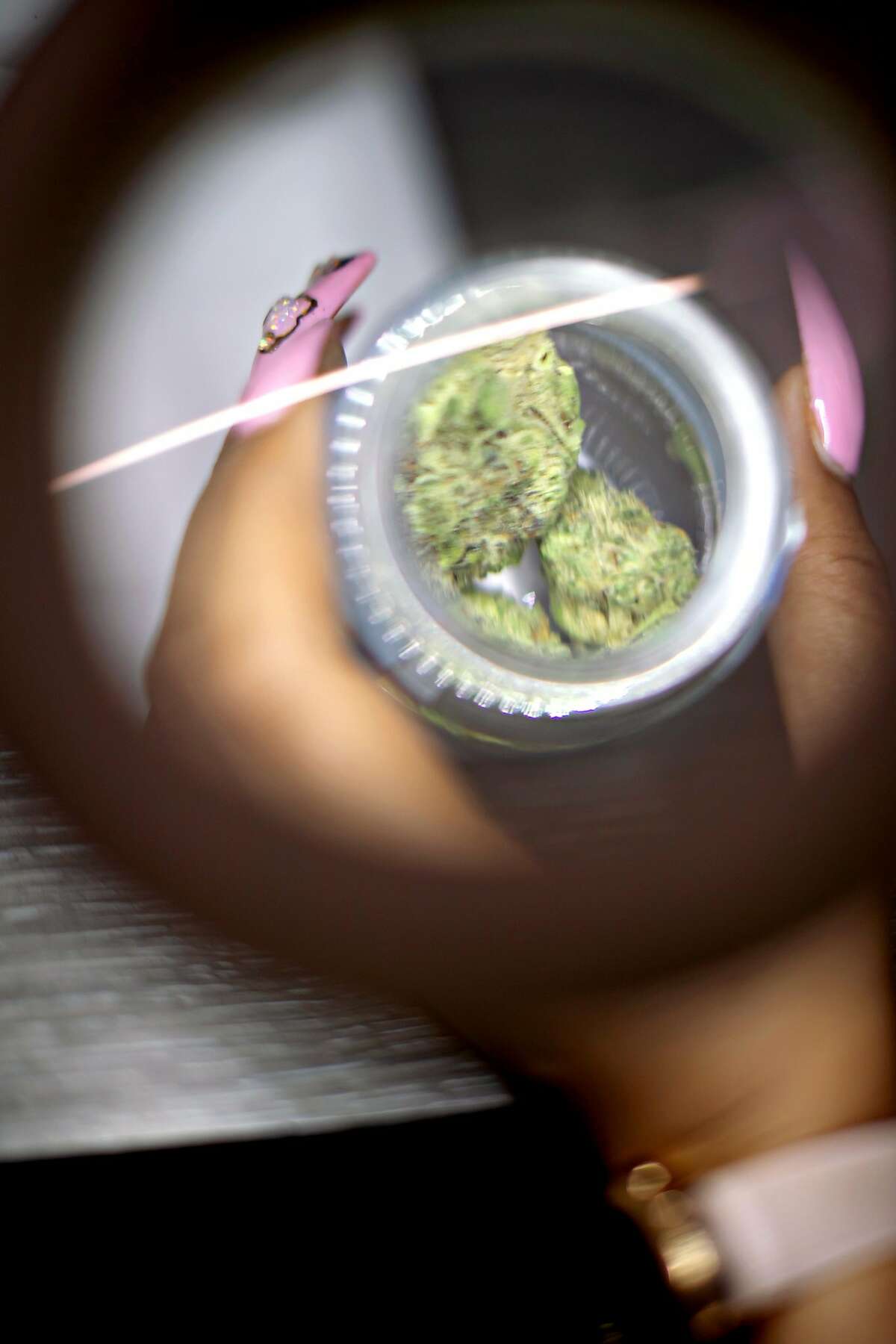 �Cookies� under a magnifying glass at Blunts and Moore, a cannabis store under Oakland�s equity program, on Wednesday, May 22, 2019, in Oakland, Calif.