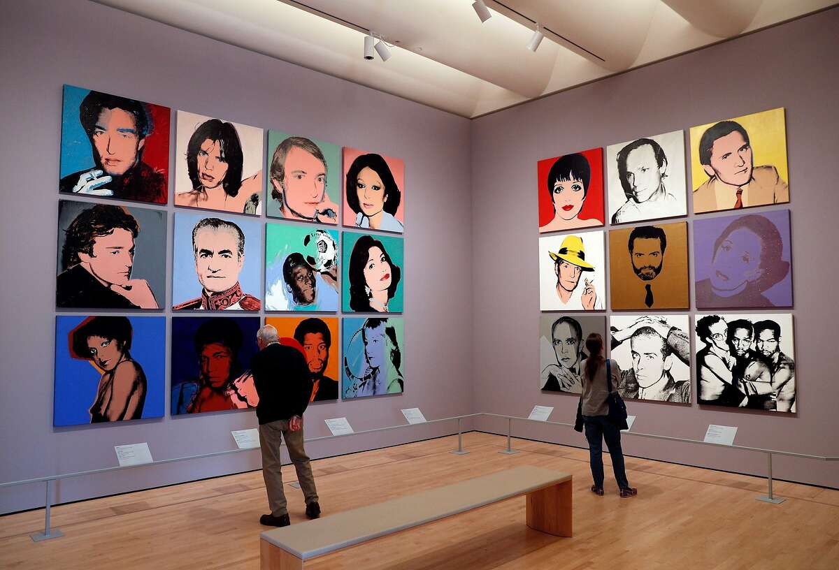 Guests look over art work in the Andy Warhol celebrity portraits gallery In the new section of the San Francisco Museum of Modern Art in San Francisco, Calif., on Monday, May 20, 2019. Visitors have enjoyed the new sections of the museum since it was completed three years ago.