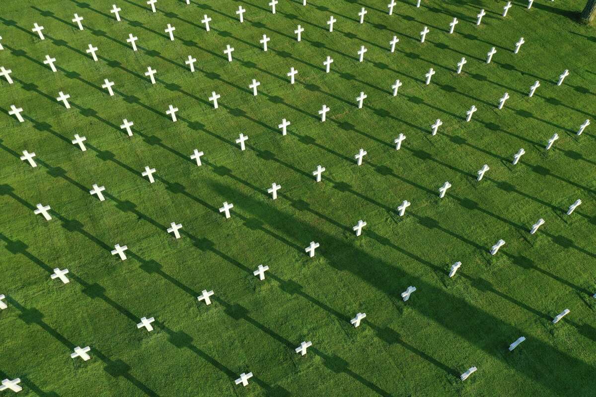 In this aerial view crosses stand over graves at Normandy American Cemetery on April 30, 2019 at Colleville-sur-Mer, France. The cemetery contains the remains of 9,380 U.S. soldiers killed during the Allied Normandy invasion. June 6, 2019, will mark the 75th anniversary of the D-Day invasion, in which a massive Allied force of U.S., British, Canadian, French and troops from other nationalities landed at beaches in Normandy to begin their push to liberate France from Nazi occupation during World War II. (Photo by Sean Gallup/Getty Images)
