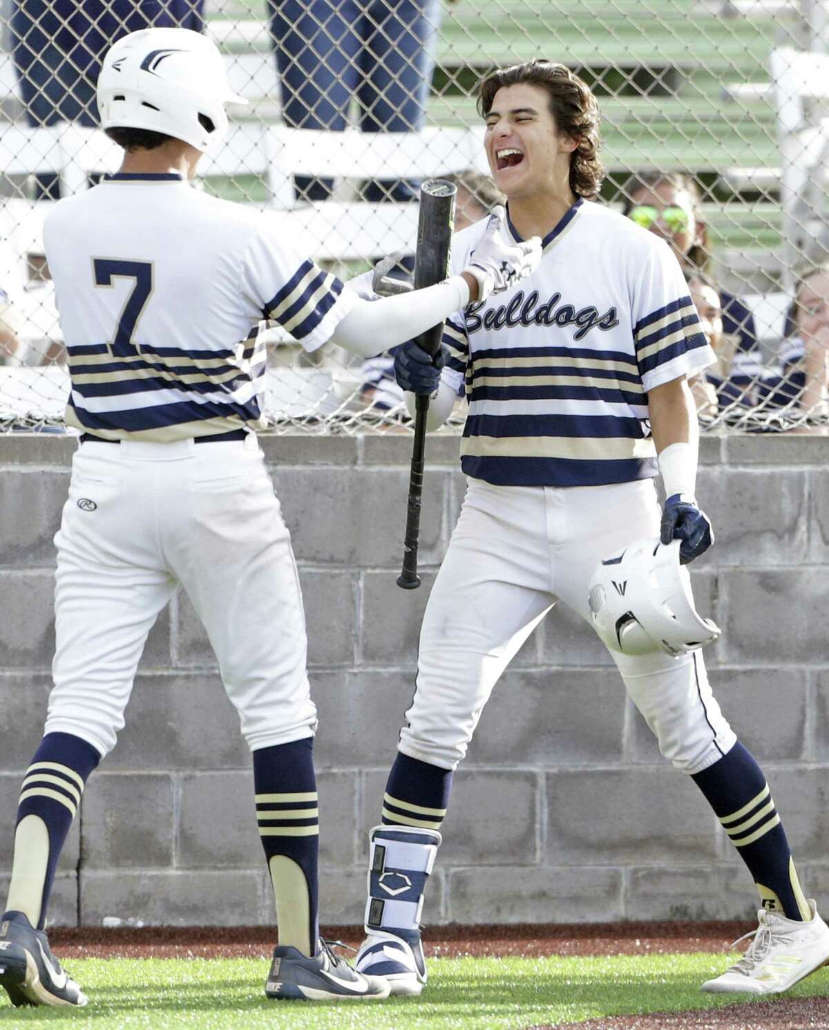 Normar Garcia, right, celebrates his two run homer in the fourth inning as the bats come alive for the Bulldogs who beat Reagan 9-8 in game 2 of the Class 6A Regional Semifinals at Cabaniss Field in Corpus Christi on May 24, 2019.