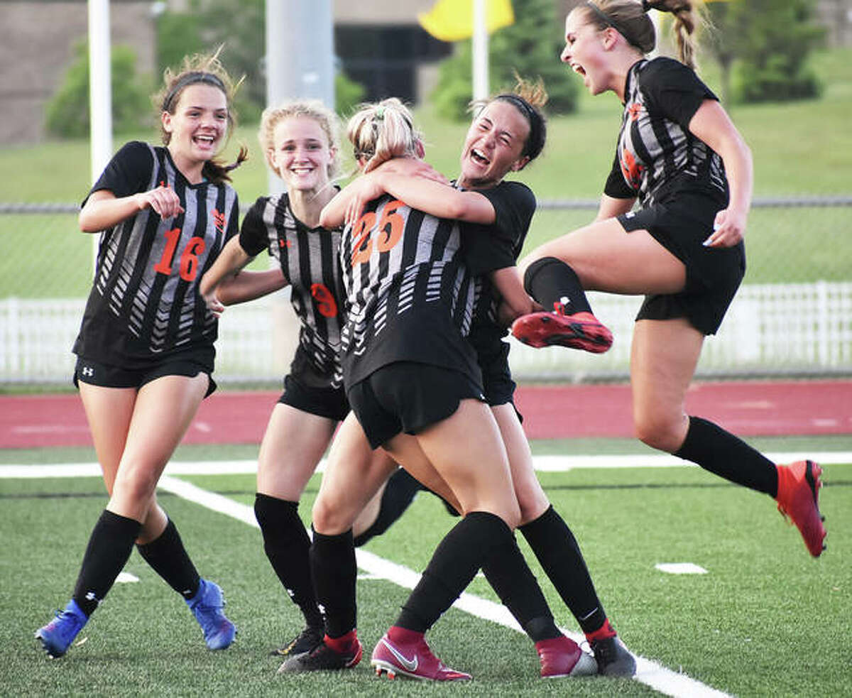 Edwardsville celebrates after Hannah Bielicke scores in the second half Friday night against Minooka in a Class 3A sectional title match in Bloomington.