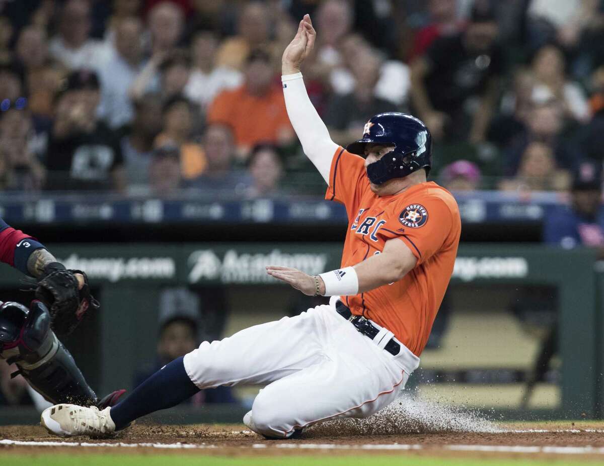 It takes some fancy footwork by a sliding Aledmys Diaz to avoid the catcher’s tag during second-inning action at the plate Friday night at Minute Maid Park.