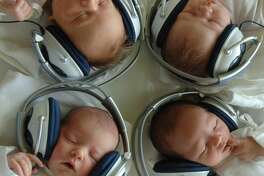 KOSICE-SACA, SLOVAKIA: One and Two-day-old newborn babies listen to music with headphones at the 1st Private Hospital in eastern Slovak metropol of Kosice-Saca 11 August 2005. The experimental program that started approximetly two years ago, is based on using musical therapy in improving the quality of carring for the newborns shortly after the birth.This project helps to stimulate the communication, adaptation and ease the stress after the birth. Presently there are thirty newborn babies daily undergoing five sessions of twenty minutes each, when they listen to a variety of musical genres from classical to easy listening. AFP PHOTO JOE KLAMAR (Photo credit should read JOE KLAMAR/AFP/Getty Images)