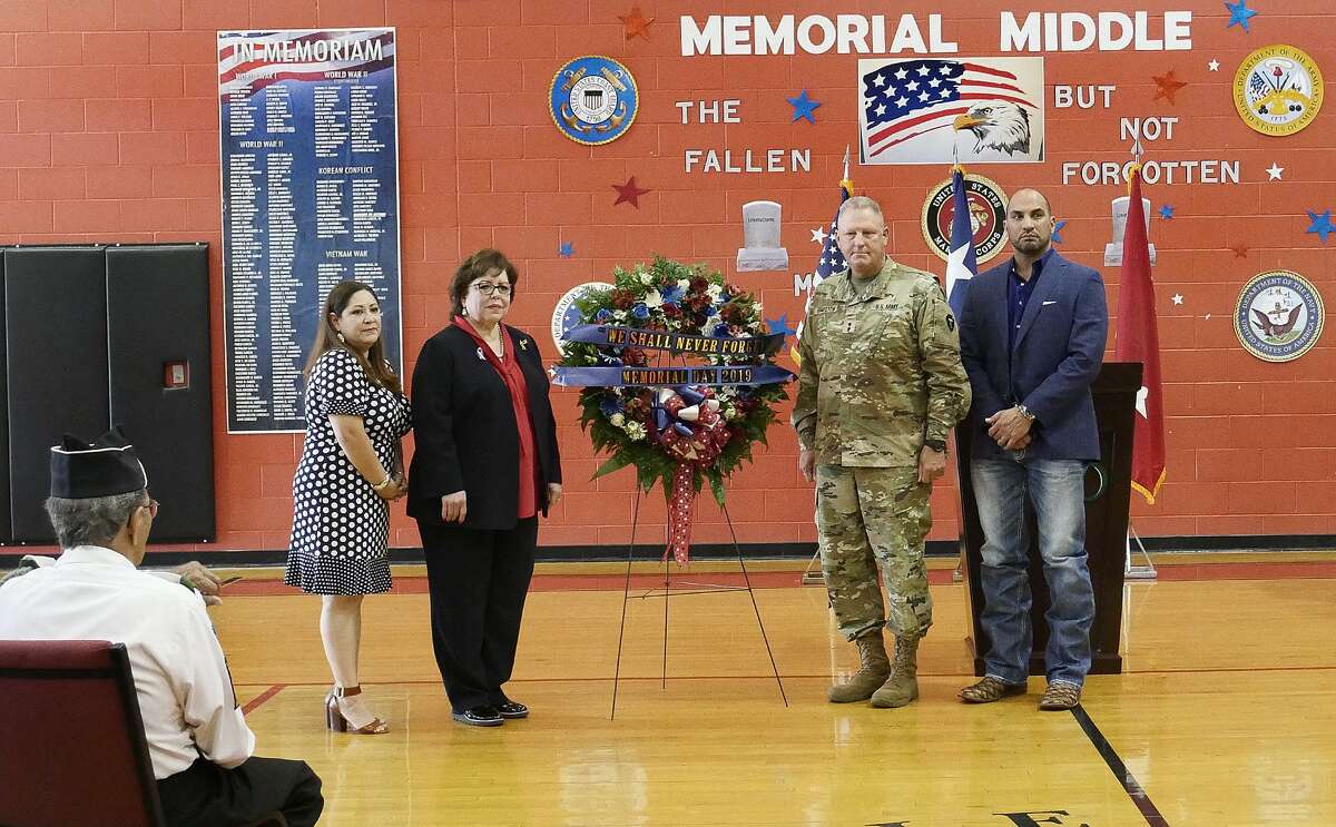 Memorial Middle School Principal Melissa Valdez, Laredo ISD Superintendent Sylvia Rios, Commanding General of the 36th Infantry Division, Major General Patrick Hamilton and Webb County Judge Tano Tijerina pose next to a memorial wreath at the LISD Memorial Day Observance at Memorial Middle School on Thursday.