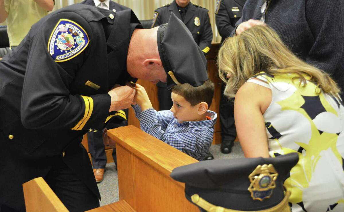 Newly installed Middletown police Capt. Richard Davis is pinned by his son May 24, 2019.