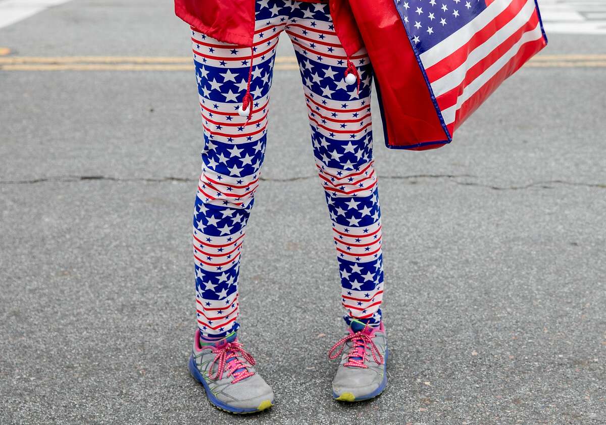 A tourist sports an American flag themed outfit during the annual Memorial Day observance held at the Presidio Cemetery in San Francisco, Calif. Monday, May 27, 2019.