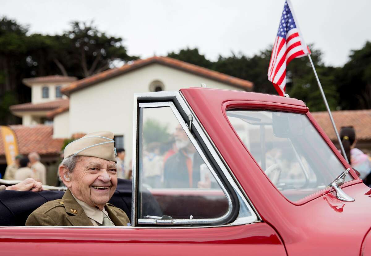 World War II veteran Bill Beckman rides in a vintage car through the Presidio during the annual Memorial Day observance held at the Presidio Cemetery in San Francisco, Calif. Monday, May 27, 2019.