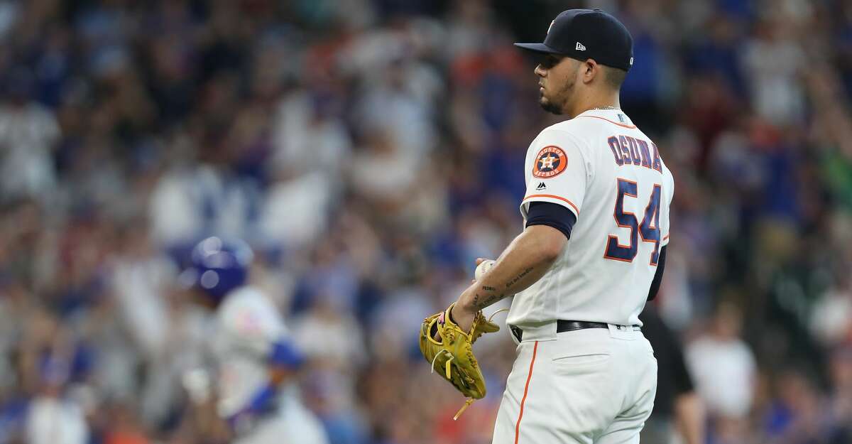 Houston Astros relief pitcher Roberto Osuna (54) reacts to Chicago Cubs shortstop Addison Russell (27) home-run during the 9th inning of an MLB baseball game at Minute Maid Park Monday, May 27, 2019, in Houston.