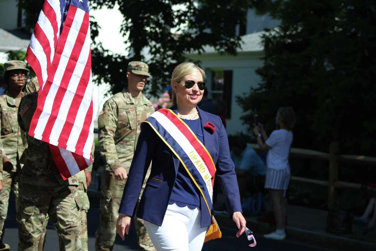 Grand Marshal Lisa Melland, a leader in the Daughters of the American Revolution, leads the Memorial Day Parade down Main Street in New Canaan on Monday.