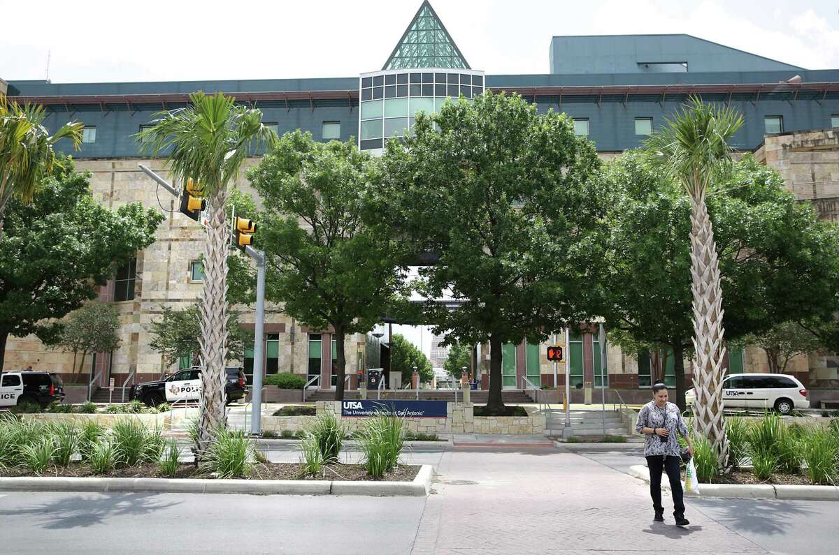 A pedestrian crosses Frio Street at the UTSA downtown campus.