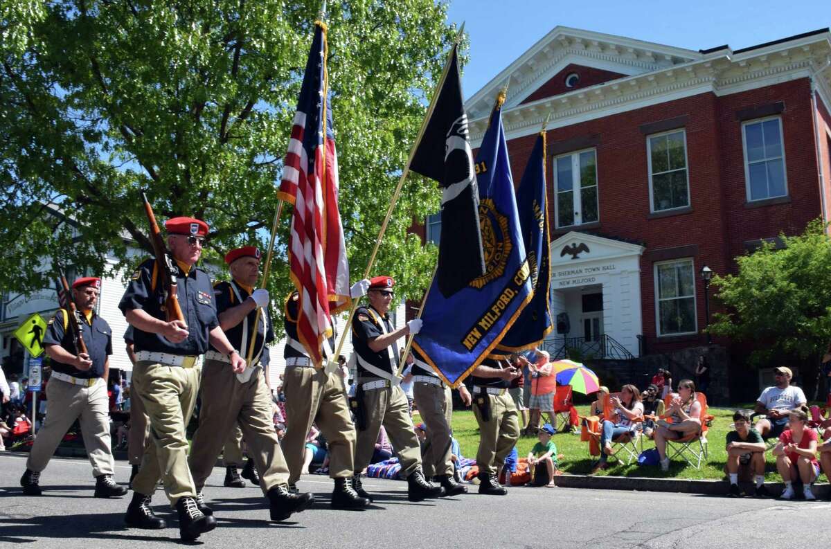 Spectrum/New Milford recognized Memorial Day with a ceremony in front of the New Milford Public Library, followed by a parade downtown. May 27, 2019. Above, veterans lead the way along the parade route on Main Street, with Roger Sherman Town Hall in the background.