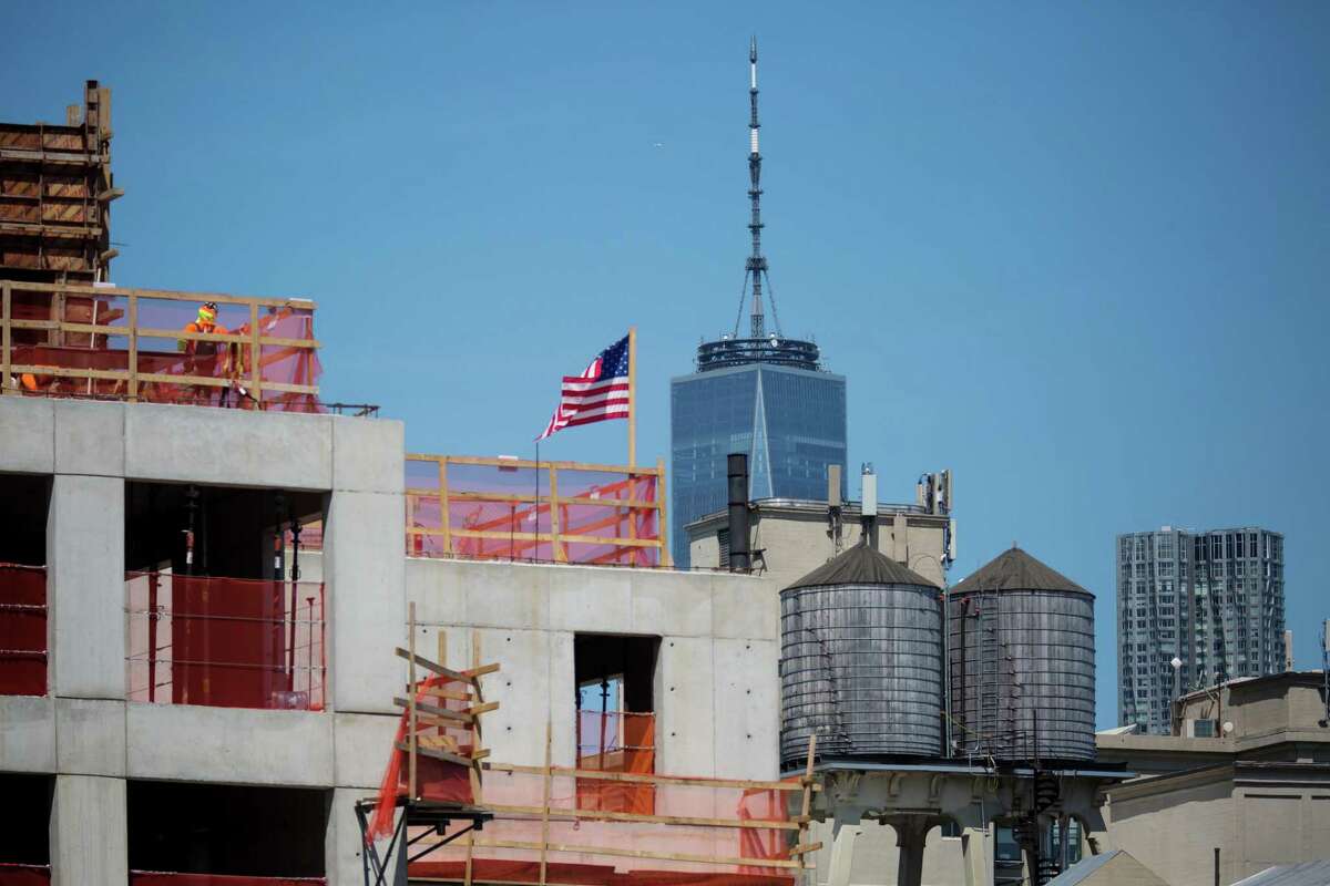 An American flag flies on top of a construction site in the Dumbo neighborhood in the Brooklyn borough of New York, U.S., on Wednesday, May 22, 2019. Stocks slumped globally on Thursday and traders took refuge in gold and bonds as the simmering trade dispute between the world's two largest economies took a greater toll on markets. Photographer: Michael Nagle/Bloomberg