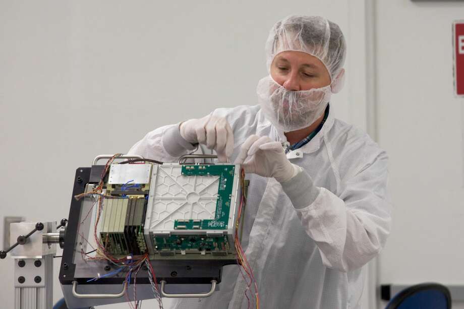 Abe Rademacher, NASA BioSentinel mechanical lead, wires the engineering development unit of the Biosentinel cube satellite which will launch on the SLS EM-1, at the NASA Ames complex at Moffett Field, California, Thursday, June 8, 2017. (Thor Swift/For the San Francisco Chronicle)