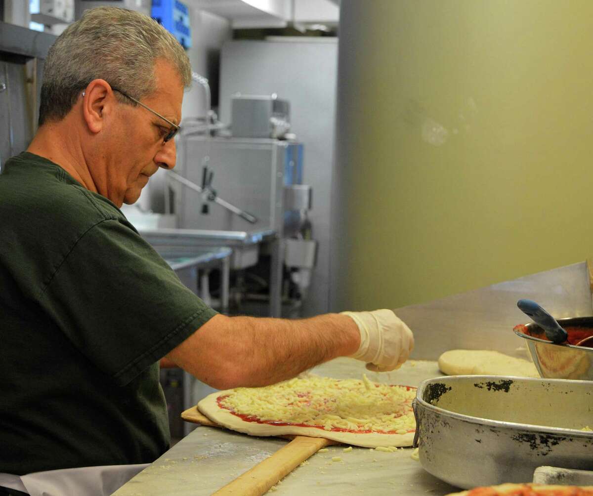 Mel Mioli, the owner and co-founder of Westport Pizzeria, spins out the pies at the eatery's location at 143 Post Road East, where it moved after 45 years on Main Street.