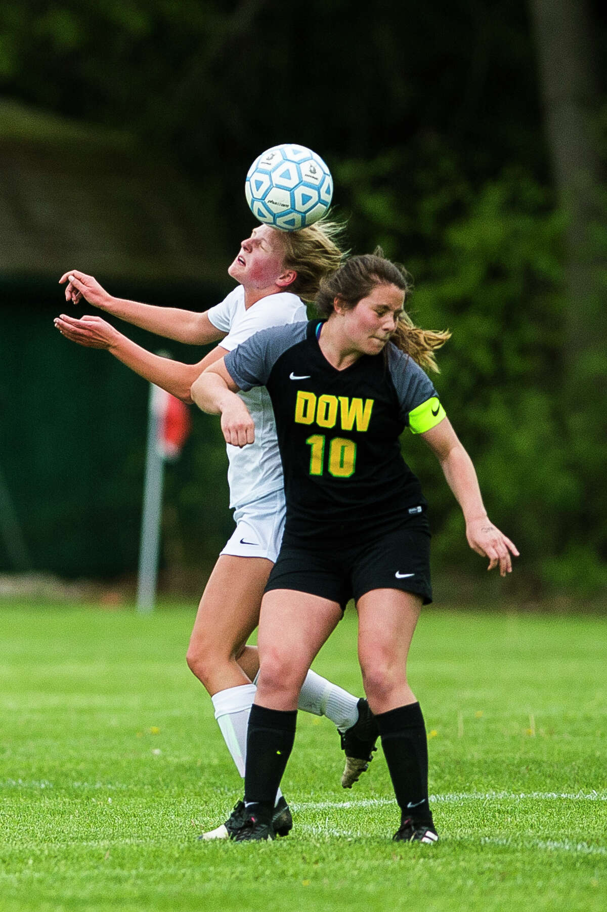 Midland's Sami Vansumeren and Dow's Elizabeth Green fight for possession during a game on Tuesday, May 28, 2019 at H. H. Dow High School. (Katy Kildee/kkildee@mdn.net)