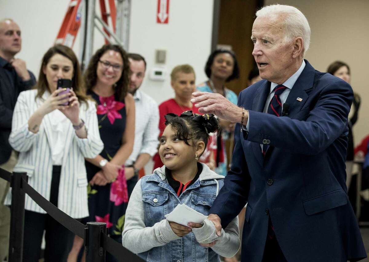 Former Vice President Joe Biden, a 2020 Democratic presidential hopeful, takes Virmania Villalobos, 10, back to introduce her to members of the media after she asked him a question during a town all meeting with a group of educators from the American Federation of Teachers on Tuesday, May 28, 2019, in Houston. Biden asked her what her favorite subject in school was and she responded: journalism. Which prompted Biden to walk her back to the media riser.