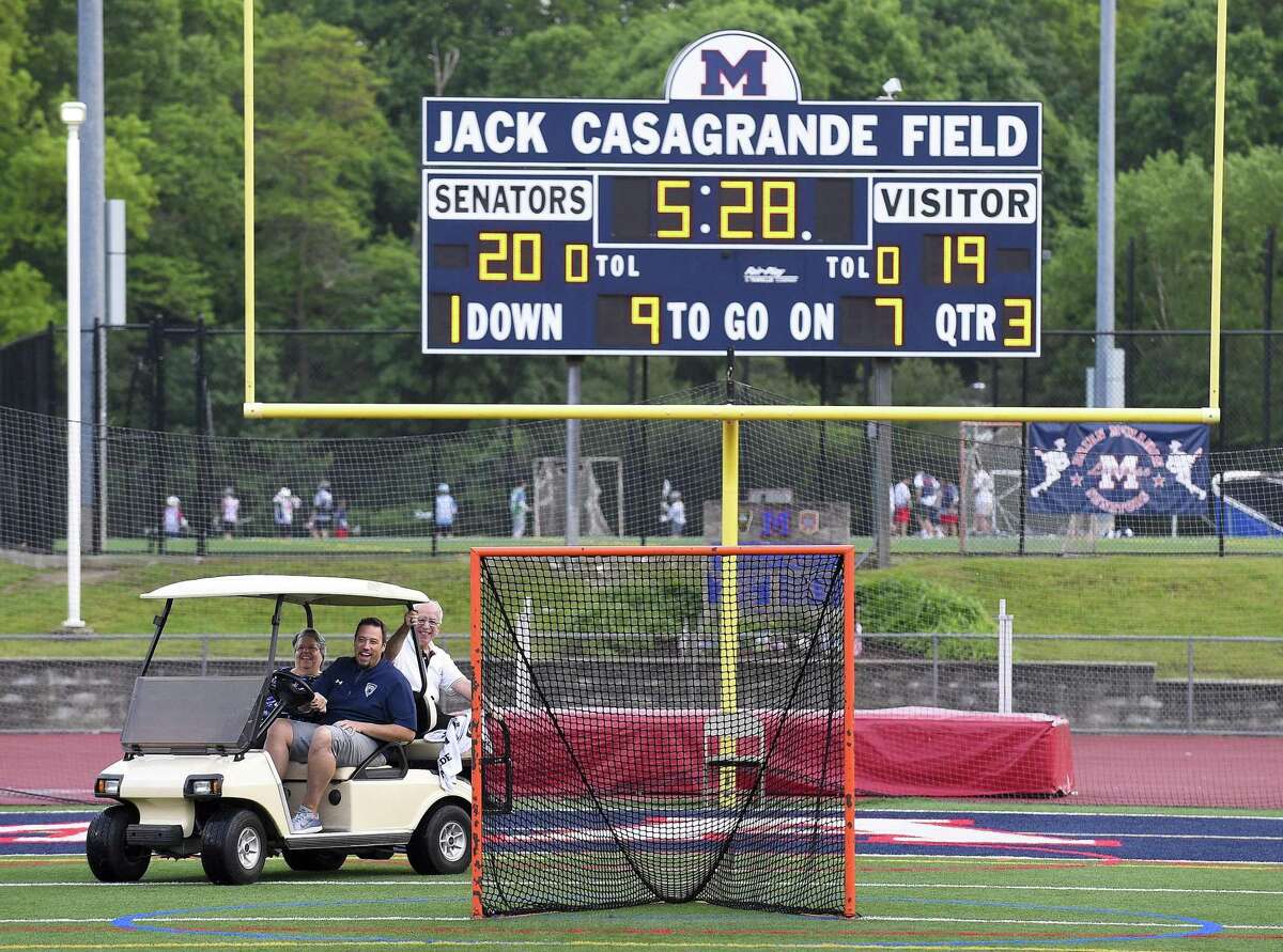Longtime former Hour sportswriter and columnist George Albano and his wife Diane are escorted into Jack Casagrande Field as he is honored with the naming of the pressbox at Brien McMahon High School on May 28, 2019 in Norwalk, Connecticut.